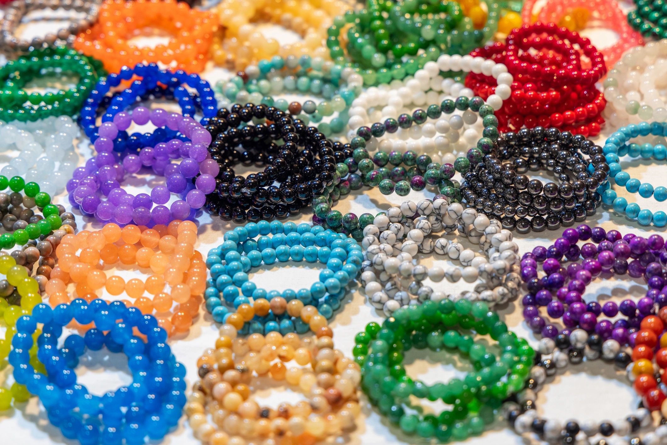 Crystal bracelets displayed in a polished, colorful arrangement